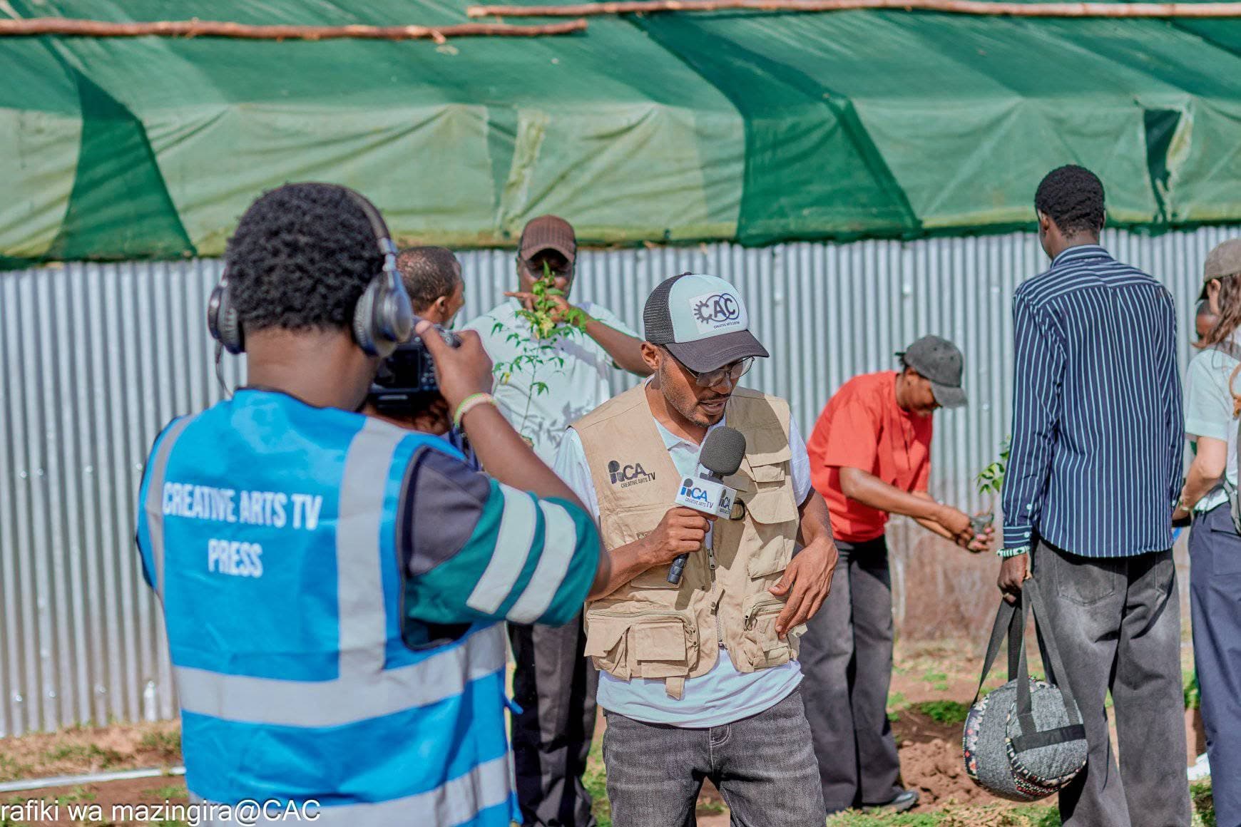 A young journalist filming an interview in Kakuma