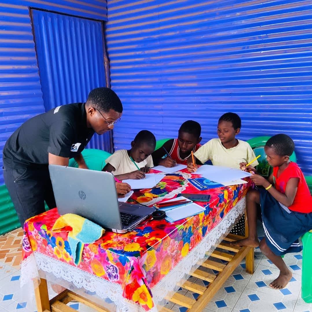 Young people learning together at computers in Kakuma