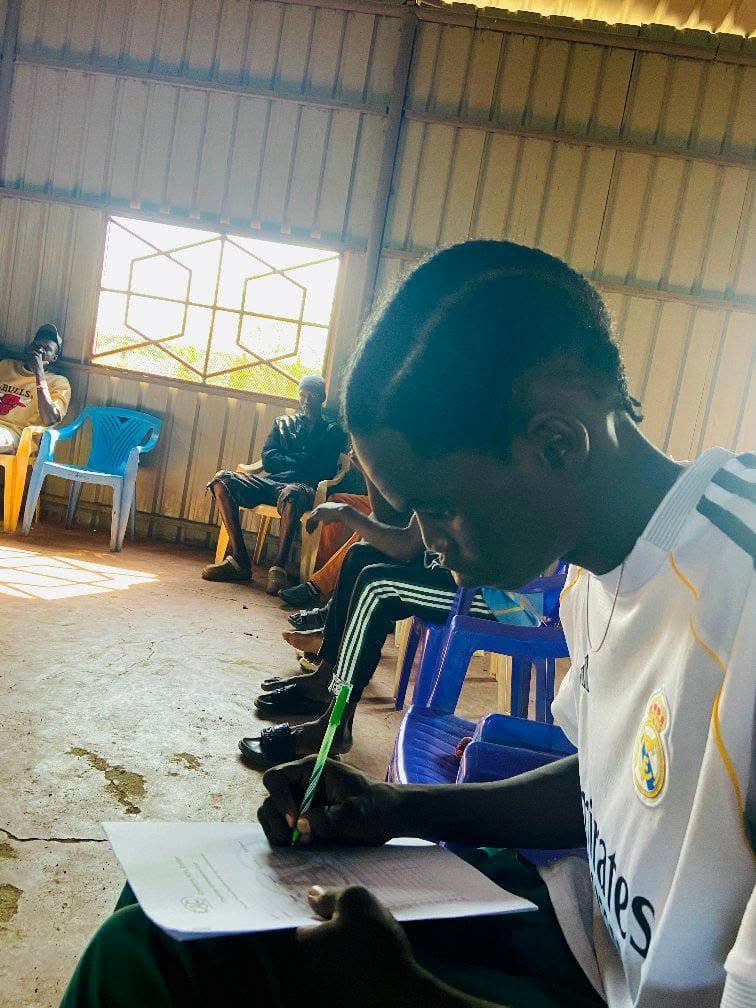 A learner writing in a notebook